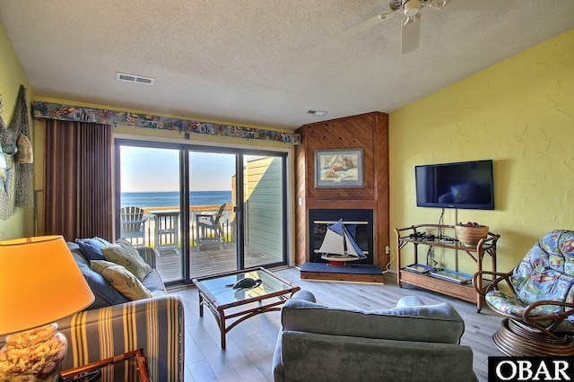 2035 S Virginia Dare Trl Unit 11, Kill Devil Hills, NC 27948 - living area featuring a textured ceiling, a ceiling fan, and wood finished floors