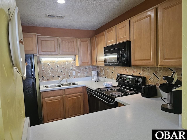 2035 S Virginia Dare Trl Unit 11, Kill Devil Hills, NC 27948 - kitchen featuring black appliances, a sink, decorative backsplash, light countertops, and a textured ceiling