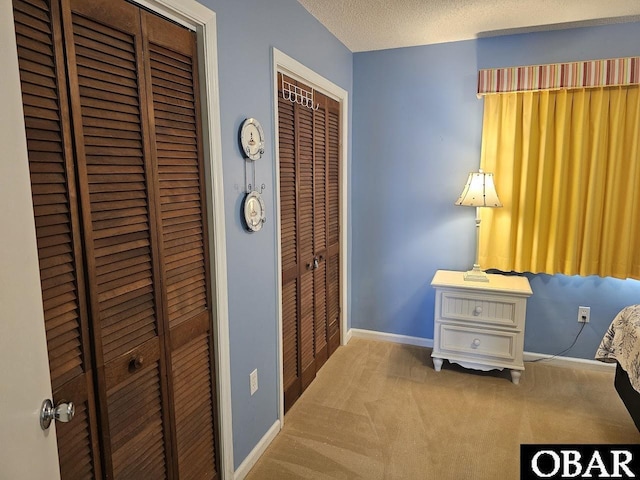 2035 S Virginia Dare Trl Unit 11, Kill Devil Hills, NC 27948 - carpeted bedroom with multiple closets and baseboards
