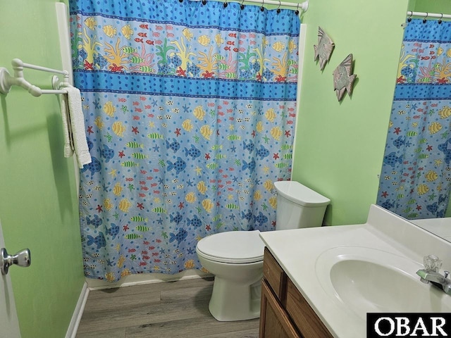 2035 S Virginia Dare Trl Unit 11, Kill Devil Hills, NC 27948 - full bath featuring wood finished floors, toilet, a shower with shower curtain, vanity, and baseboards