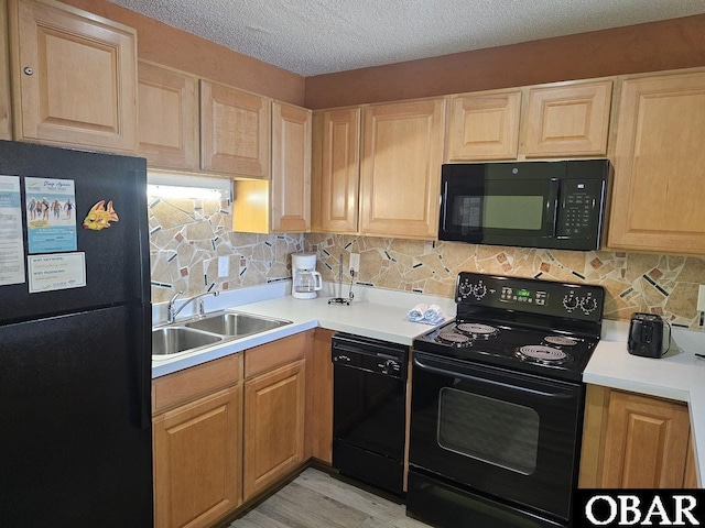 2035 S Virginia Dare Trl Unit 11, Kill Devil Hills, NC 27948 - kitchen with black appliances, a sink, decorative backsplash, light countertops, and light brown cabinetry