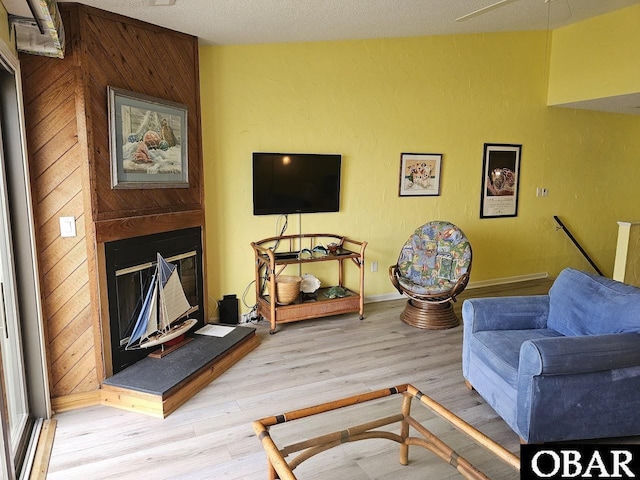 2035 S Virginia Dare Trl Unit 11, Kill Devil Hills, NC 27948 - living area featuring light wood-style flooring, baseboards, and a fireplace