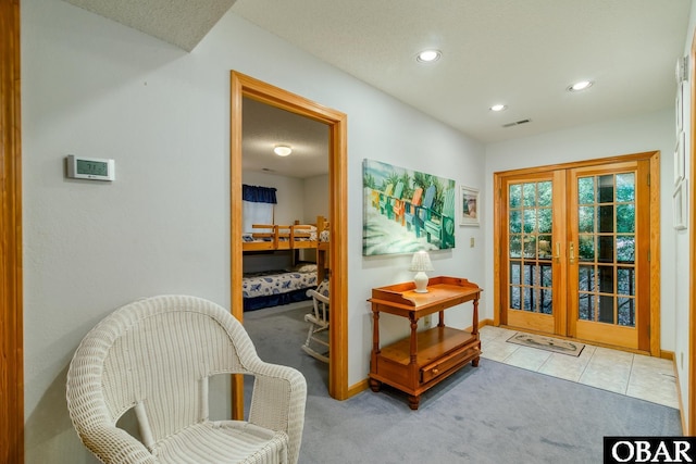 interior space featuring visible vents, recessed lighting, french doors, and carpet floors