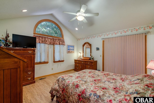 bedroom featuring visible vents, baseboards, ceiling fan, vaulted ceiling, and light wood-style floors