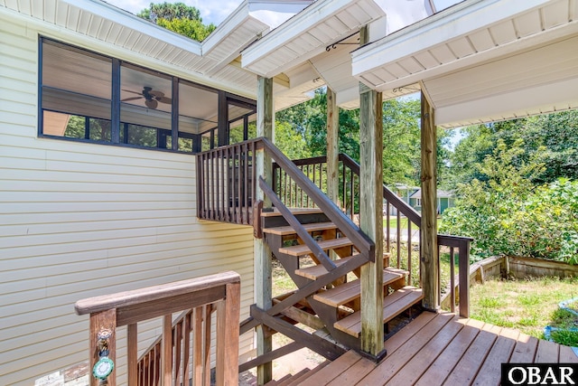 deck featuring stairway and a sunroom