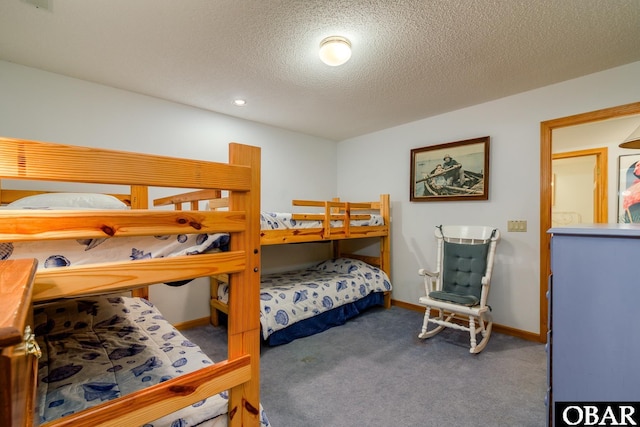 bedroom featuring baseboards, a textured ceiling, and carpet flooring