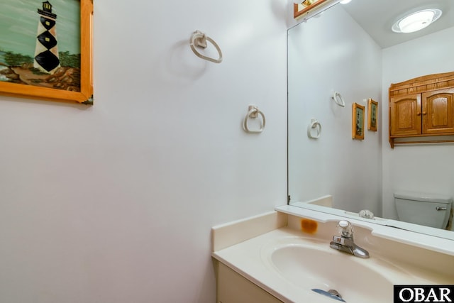 bathroom featuring toilet and vanity