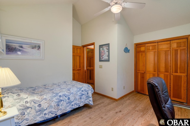 bedroom with lofted ceiling, a ceiling fan, a closet, light wood-style floors, and baseboards