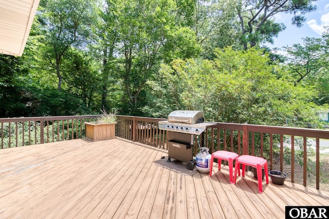 wooden terrace with a grill