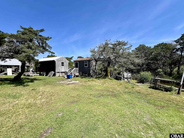 108 Loop Rd, Ocracoke, NC 27960 - view of grassy yard featuring an outbuilding