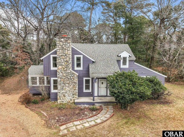 72 Poteskeet Trl Lot # 396, Southern Shores, NC 27949 - view of front of home featuring roof with shingles and a chimney
