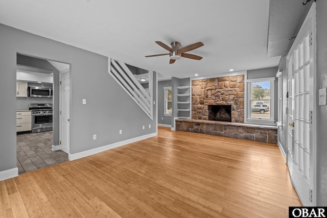 72 Poteskeet Trl Lot # 396, Southern Shores, NC 27949 - unfurnished living room featuring baseboards, ceiling fan, a fireplace, recessed lighting, and light wood finished floors