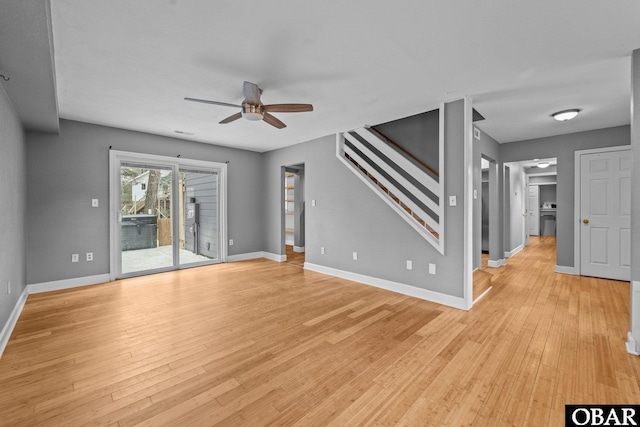 unfurnished living room with light wood-style flooring, stairs, baseboards, and ceiling fan