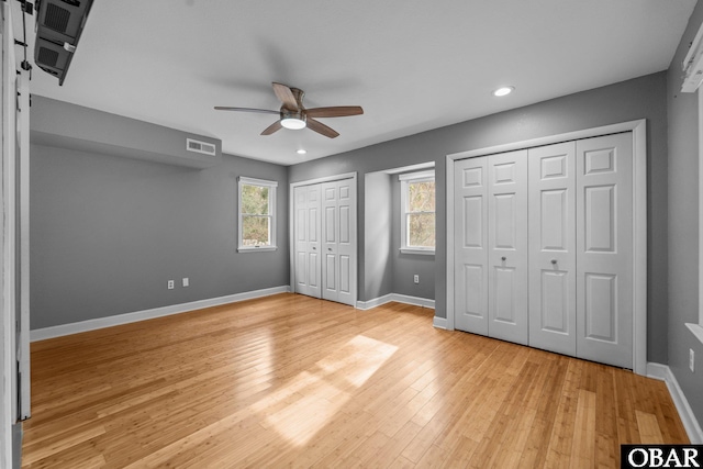 72 Poteskeet Trl Lot # 396, Southern Shores, NC 27949 - unfurnished bedroom with two closets, light wood-style floors, recessed lighting, and ceiling fan