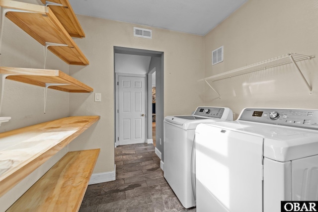 72 Poteskeet Trl Lot # 396, Southern Shores, NC 27949 - clothes washing area featuring baseboards, visible vents, laundry area, stone finish flooring, and washer and dryer
