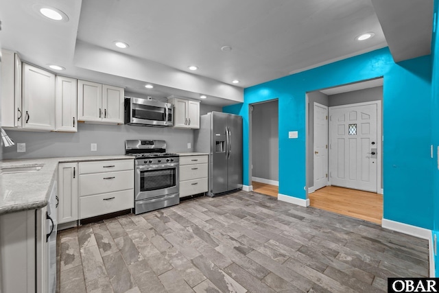 72 Poteskeet Trl Lot # 396, Southern Shores, NC 27949 - kitchen featuring white cabinets, baseboards, recessed lighting, and stainless steel appliances