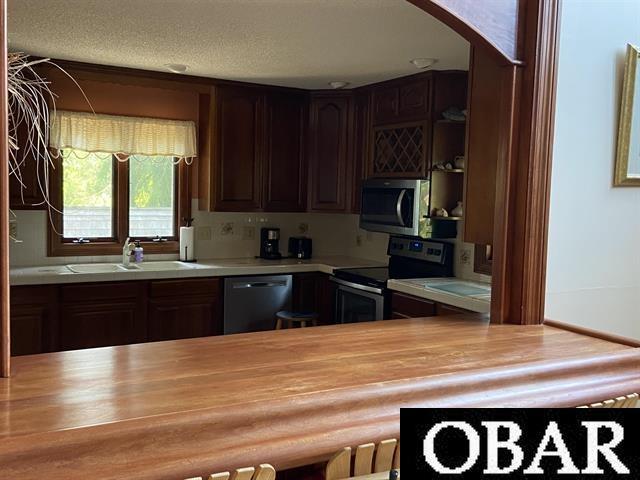 106 Middle Rd Lot 11, 12, Ocracoke, NC 27960 - kitchen featuring stainless steel appliances, wooden counters, a sink, and arched walkways