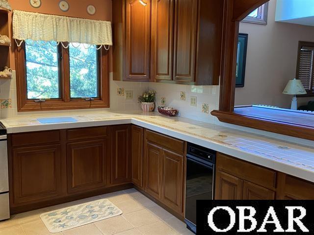 106 Middle Rd Lot 11, 12, Ocracoke, NC 27960 - kitchen featuring light countertops, backsplash, light tile patterned floors, and stove