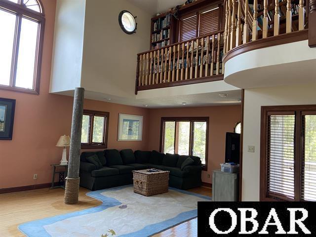 106 Middle Rd Lot 11, 12, Ocracoke, NC 27960 - living area featuring a high ceiling, wood finished floors, plenty of natural light, and baseboards