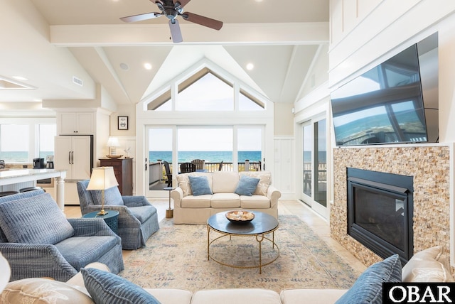 367 Lindsey Ln Lot 1, Corolla, NC 27927 - living area featuring a glass covered fireplace, lofted ceiling with beams, a ceiling fan, and recessed lighting