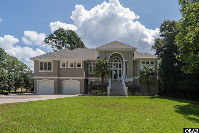 2001 Creek Rd Lot 16, Kitty Hawk, NC 27949 - mediterranean / spanish house featuring stucco siding, a garage, concrete driveway, and a front lawn