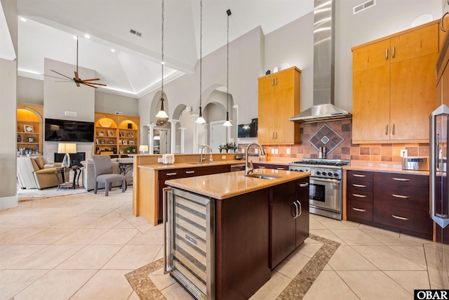 2001 Creek Rd Lot 16, Kitty Hawk, NC 27949 - kitchen with high vaulted ceiling, high end stove, beverage cooler, wall chimney range hood, and an island with sink