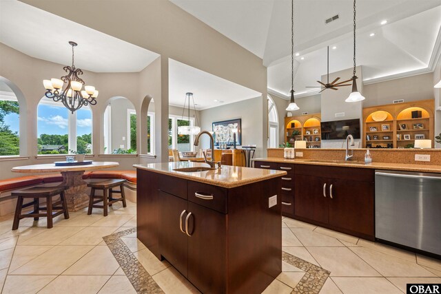 2001 Creek Rd Lot 16, Kitty Hawk, NC 27949 - kitchen with stainless steel dishwasher, an island with sink, light tile patterned floors, hanging light fixtures, and a high ceiling