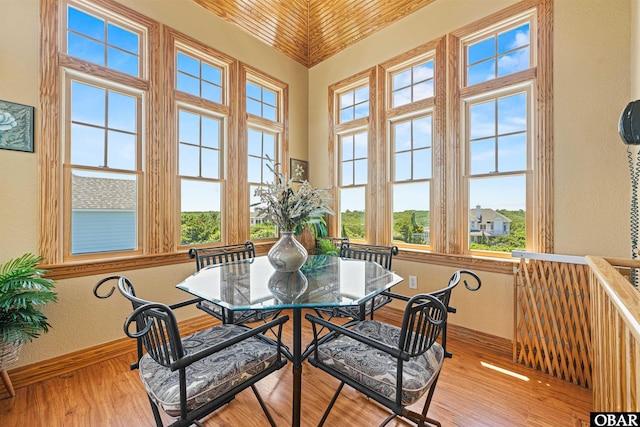 369 Deep Neck Rd Lot # 139, Corolla, NC 27927 - dining space with a textured wall, wood finished floors, and a towering ceiling