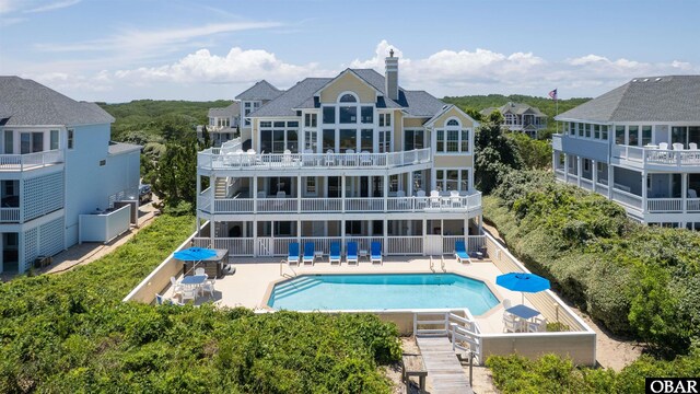 369 Deep Neck Rd Lot # 139, Corolla, NC 27927 - rear view of property with a patio area, an outdoor pool, and a chimney