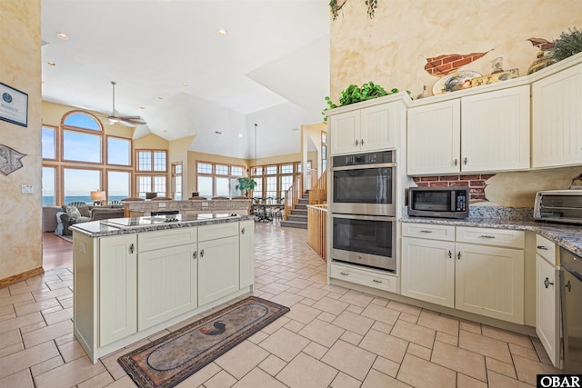 369 Deep Neck Rd Lot # 139, Corolla, NC 27927 - kitchen with stainless steel appliances, ceiling fan, open floor plan, high vaulted ceiling, and decorative backsplash