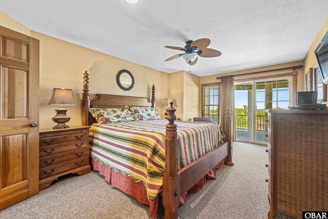 369 Deep Neck Rd Lot # 139, Corolla, NC 27927 - carpeted bedroom with access to outside, ceiling fan, and a textured ceiling