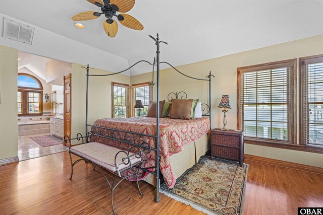 369 Deep Neck Rd Lot # 139, Corolla, NC 27927 - bedroom featuring multiple windows, wood finished floors, and connected bathroom