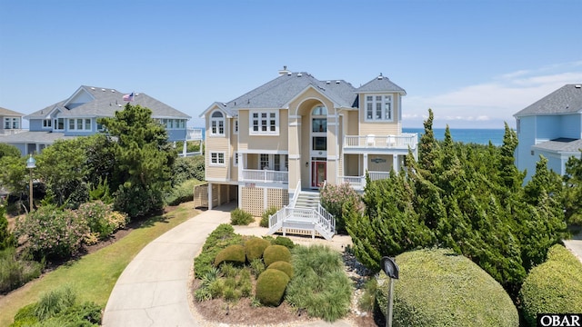369 Deep Neck Rd Lot # 139, Corolla, NC 27927 - view of front of home featuring a balcony, concrete driveway, stairway, a carport, and a porch