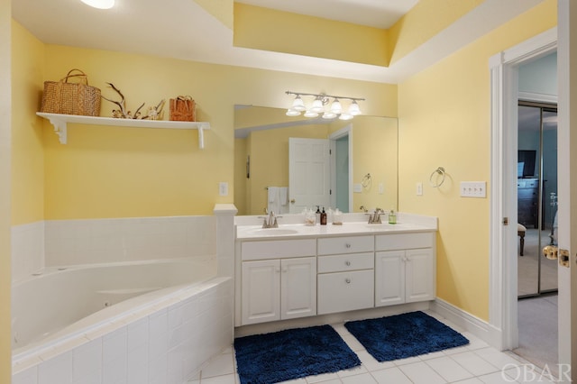 full bathroom with tile patterned flooring, a sink, a bath, and double vanity