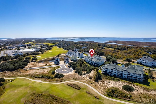 drone / aerial view with a water view and view of golf course