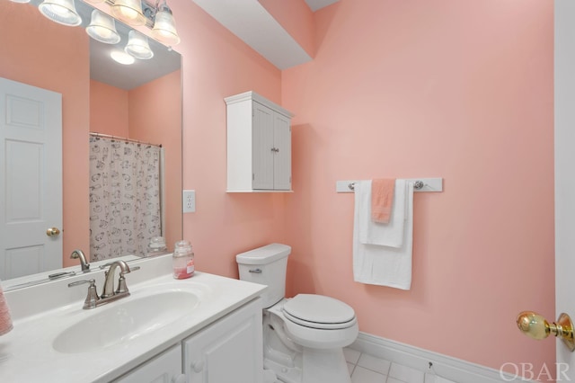 bathroom featuring a shower with curtain, toilet, vanity, tile patterned flooring, and baseboards