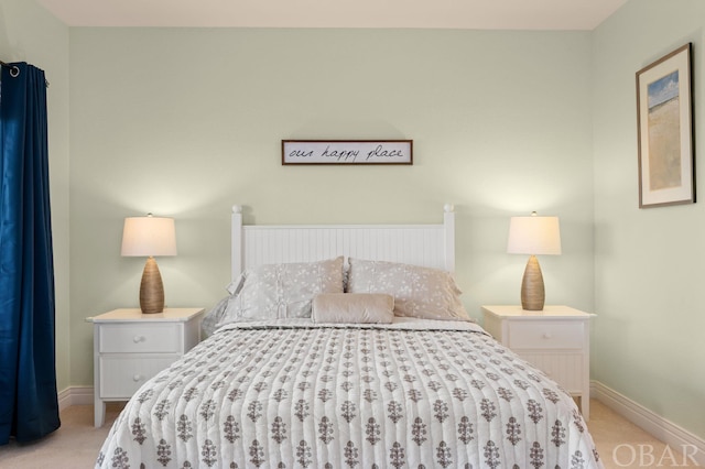 bedroom featuring baseboards and light colored carpet