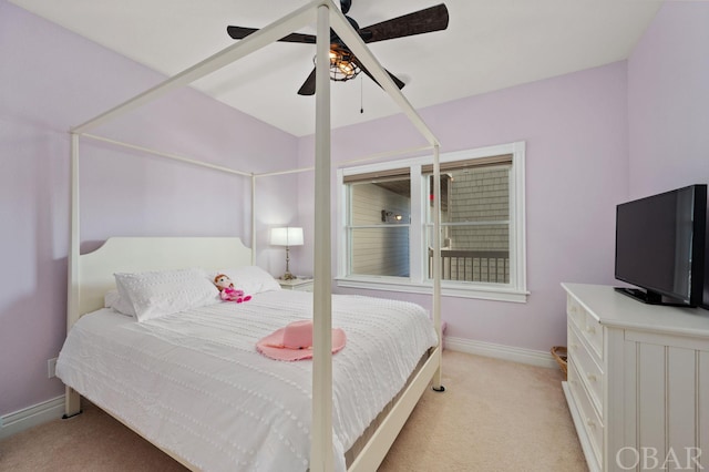 bedroom featuring ceiling fan, baseboards, and light colored carpet