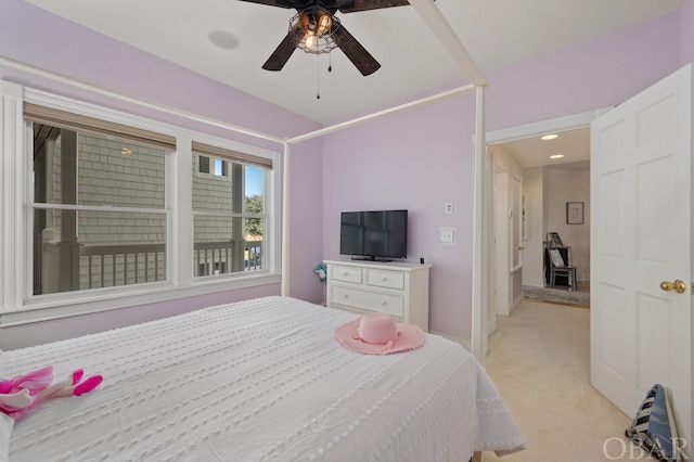 bedroom with a ceiling fan and light carpet