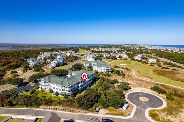 drone / aerial view with a residential view and a water view