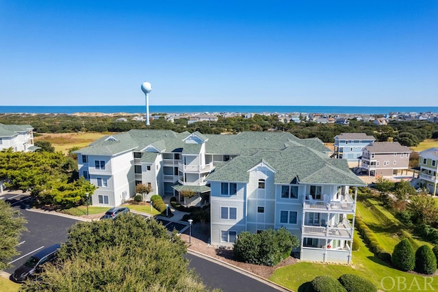 birds eye view of property featuring a water view and a residential view