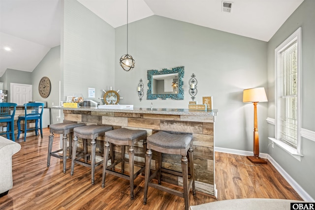 106 Flight Dr Lot 4, Duck, NC 27949 - bar area featuring lofted ceiling, wood finished floors, healthy amount of natural light, and fridge