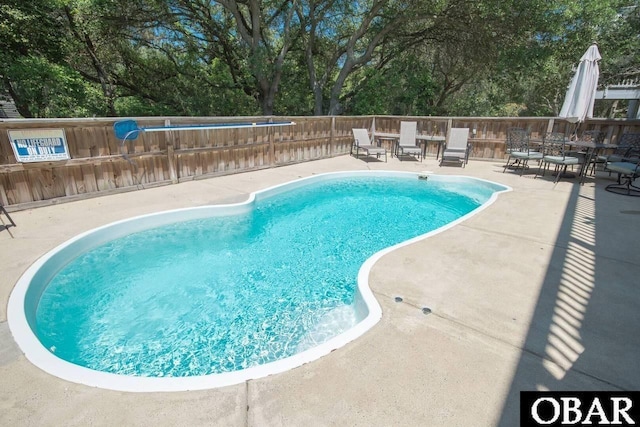 106 Flight Dr Lot 4, Duck, NC 27949 - view of pool featuring a patio area, view of scattered trees, and outdoor dining space