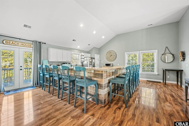 106 Flight Dr Lot 4, Duck, NC 27949 - kitchen featuring stainless steel refrigerator with ice dispenser, wood finished floors, white cabinetry, french doors, and recessed lighting