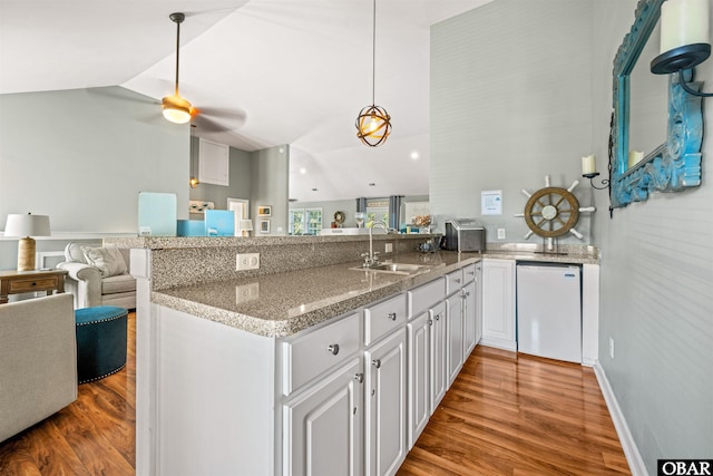 106 Flight Dr Lot 4, Duck, NC 27949 - kitchen with vaulted ceiling, open floor plan, a peninsula, light wood finished floors, and fridge