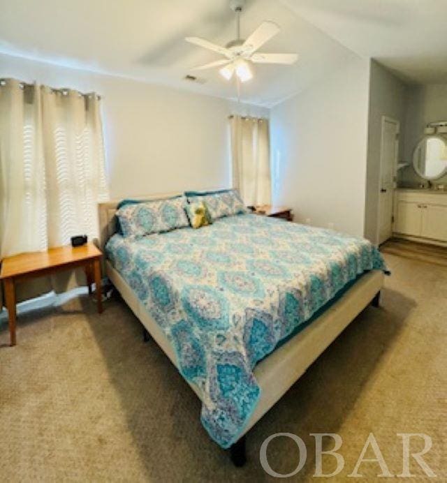 carpeted bedroom with visible vents and ceiling fan