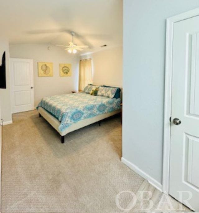 bedroom with light carpet, ceiling fan, and baseboards