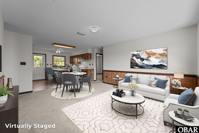 116 W Old Cove Rd Lot 1, Nags Head, NC 27959 - living area featuring a textured ceiling, light carpet, visible vents, and a wainscoted wall