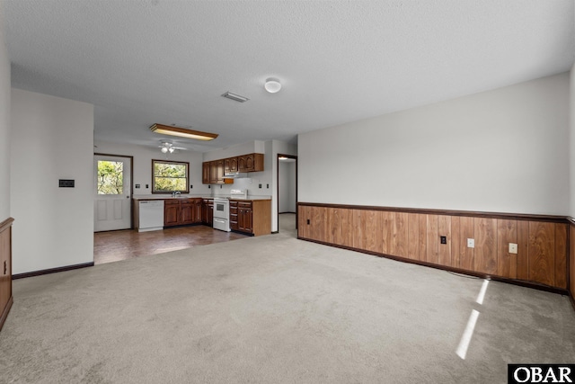 116 W Old Cove Rd Lot 1, Nags Head, NC 27959 - unfurnished living room with a textured ceiling, baseboards, dark colored carpet, visible vents, and a sink