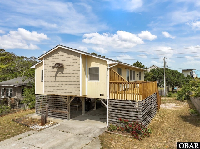 116 W Old Cove Rd Lot 1, Nags Head, NC 27959 - manufactured / mobile home with concrete driveway, a deck, fence, and a carport